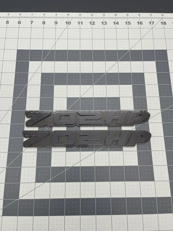 702HP grille badge